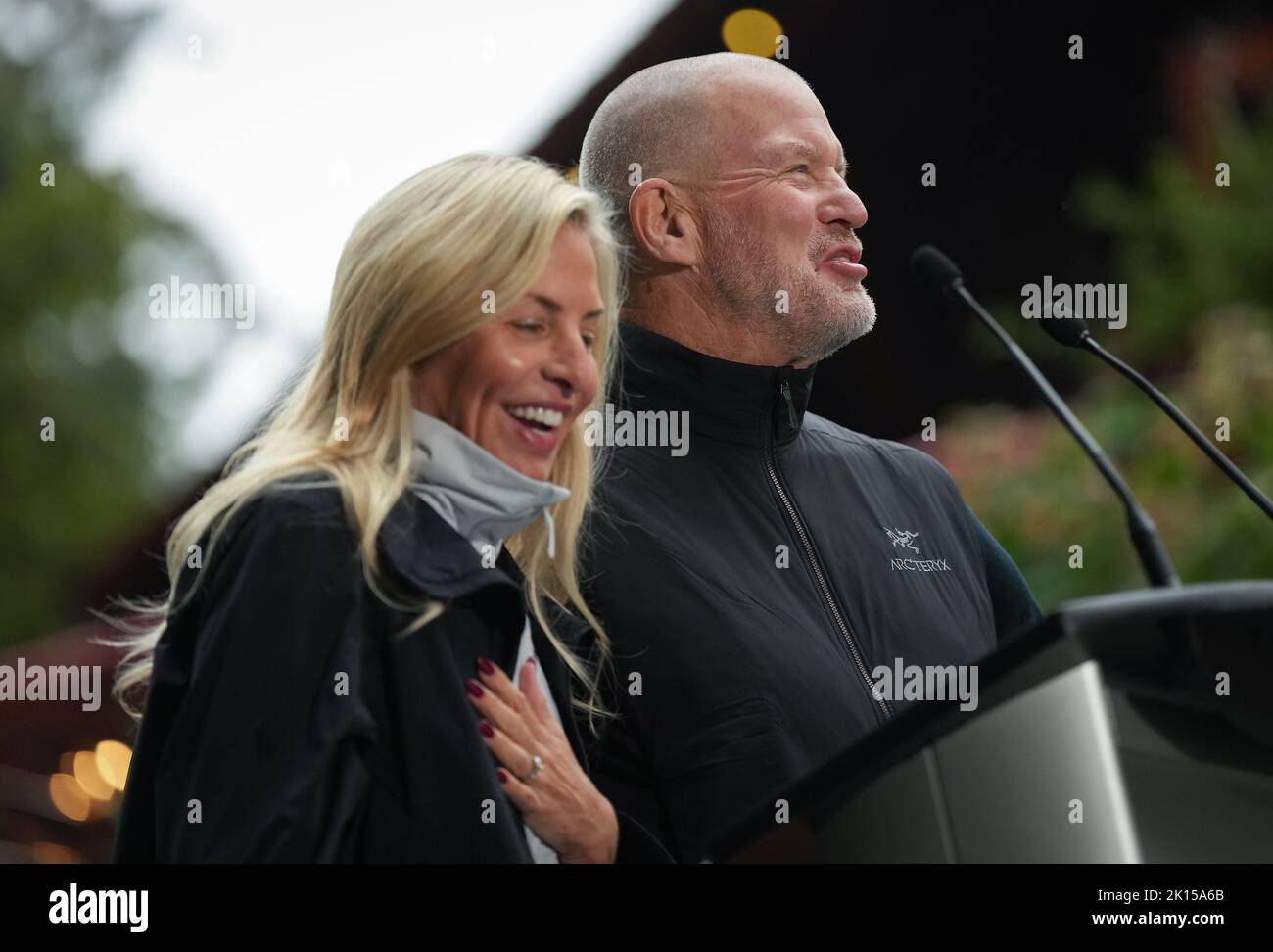 Lululemon founder Chip Wilson and his wife Summer Wilson laugh while