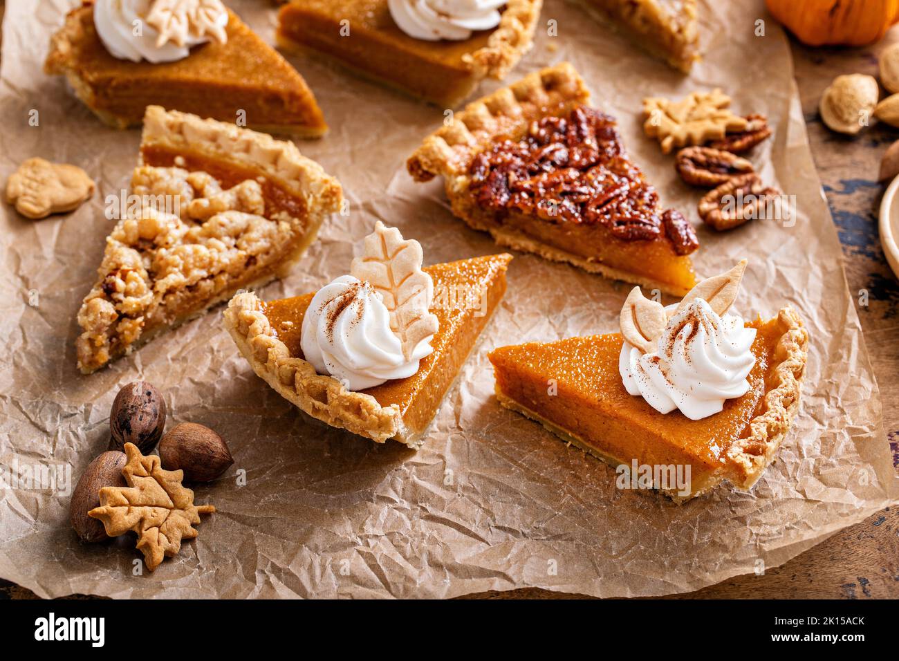 Variety of Thanksgiving pie slices on parchment paper Stock Photo