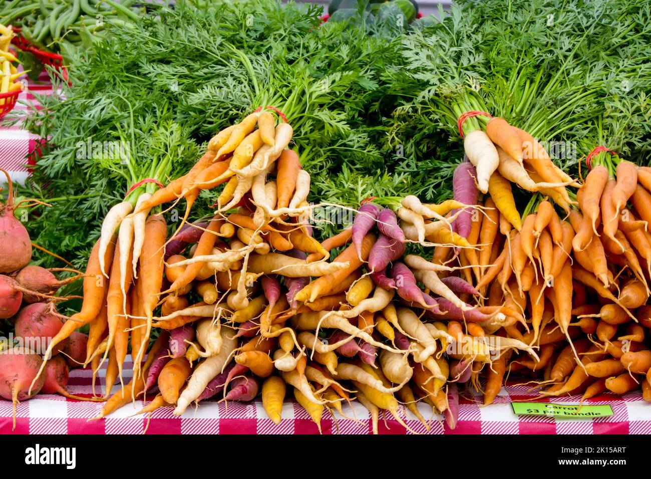 Multi-colored carrots for sale at farmers market. Stock Photo