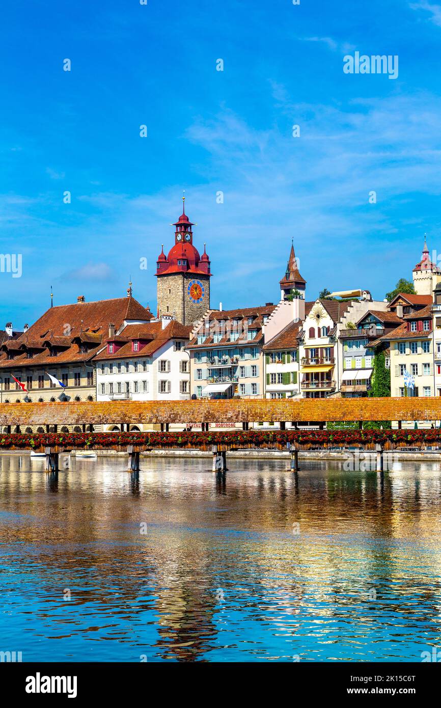 View of houses along the bank of River Russ and the wooden Chapel Bridge (Kapellbrücke), Lucerne, Switzerland Stock Photo