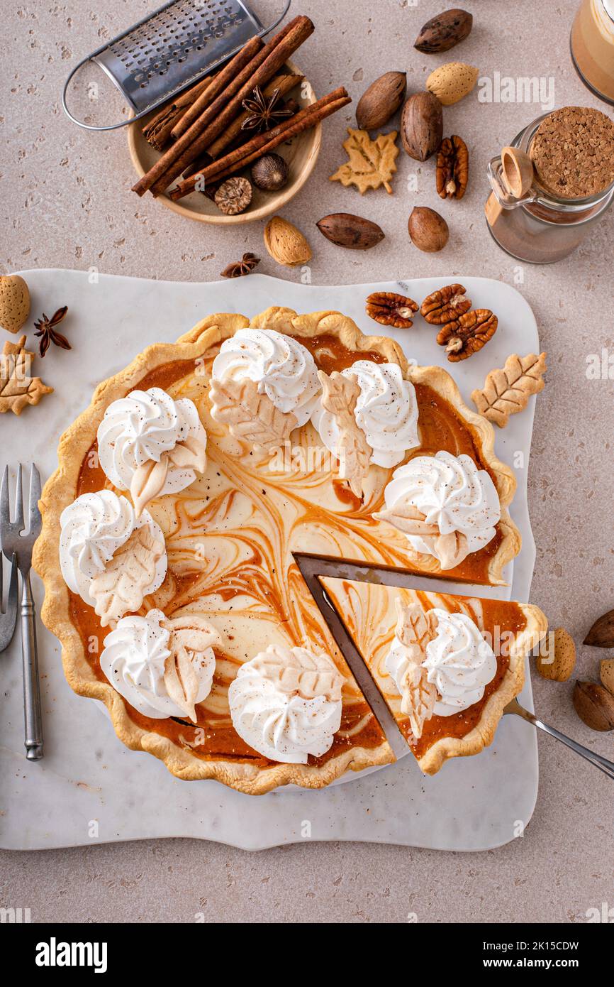 Pumpkin cheesecake swirl pie topped with whipped cream Stock Photo