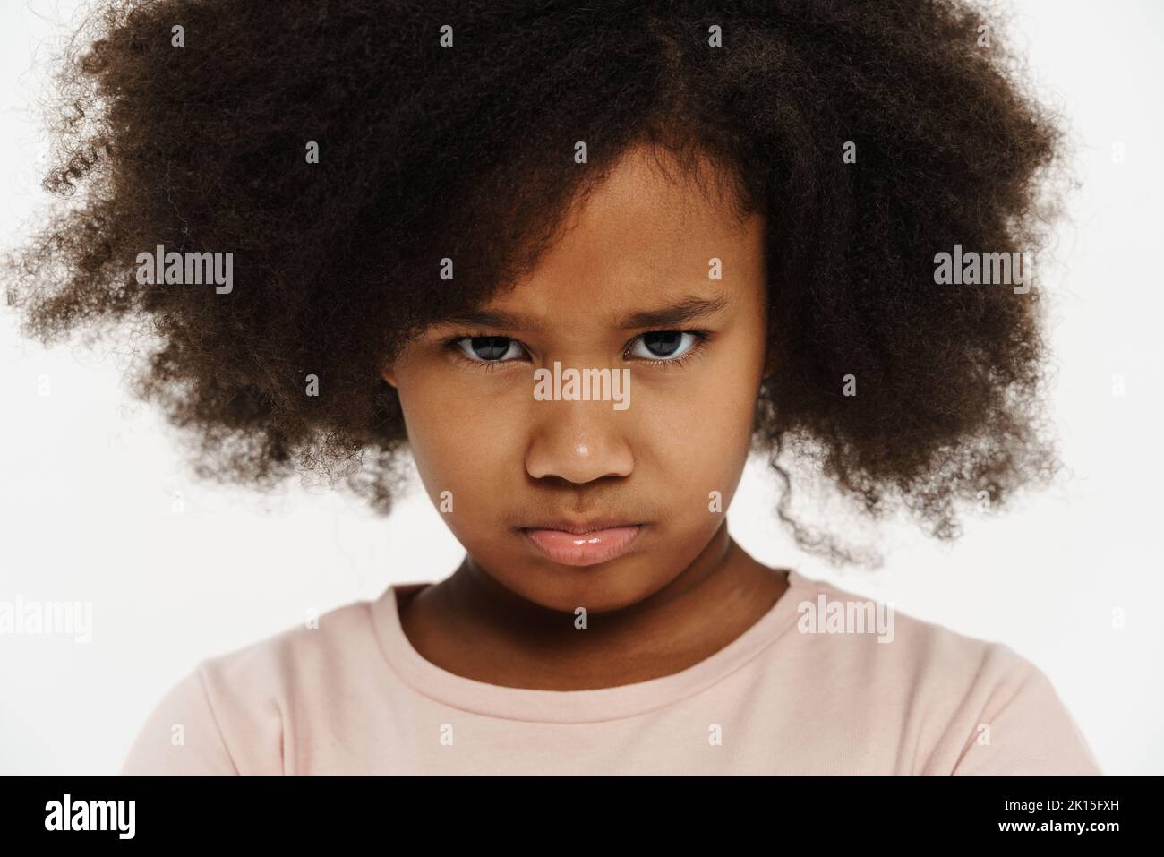 Blackgirl with curly hair frowning and looking at camera Blackgirl with curly hair frowning and looking at camera