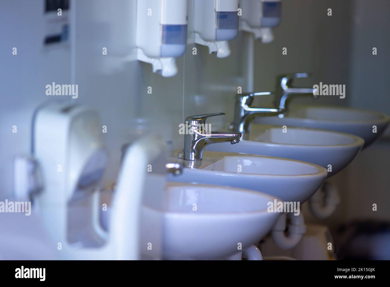 Public toilet with few washing basins. Hygienic concept Stock Photo Alamy