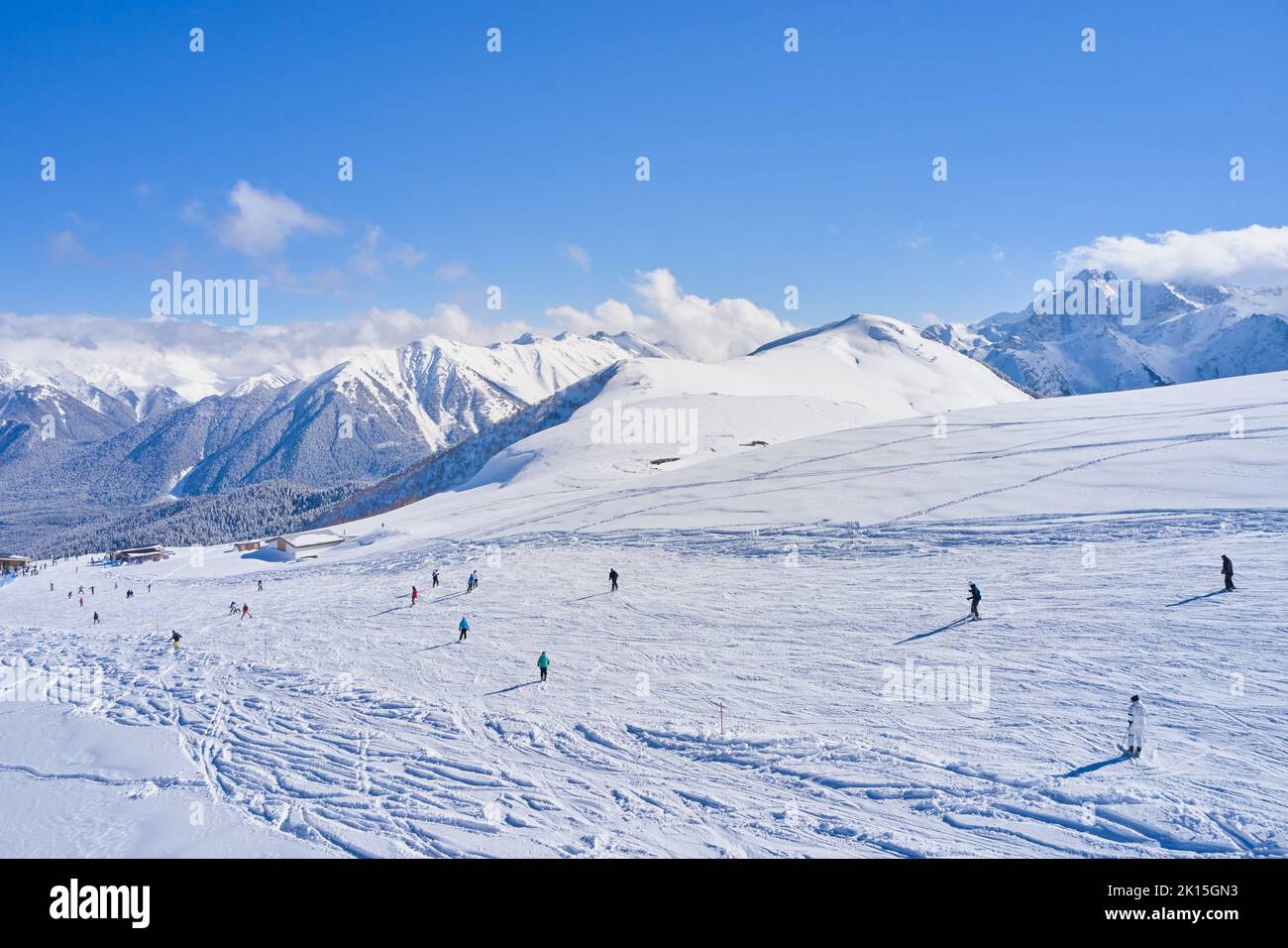 People on the ski slope on a sunny day. Stock Photo
