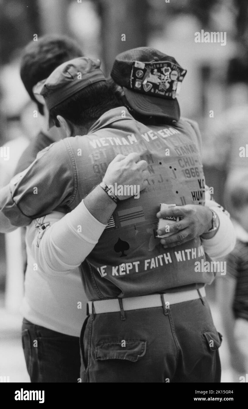 Two veterans of Vietnam, who had not seen each other for years, embrace at the memorial dedication in May, 1987, in Capitol Square, Raleigh, NC. Stock Photo