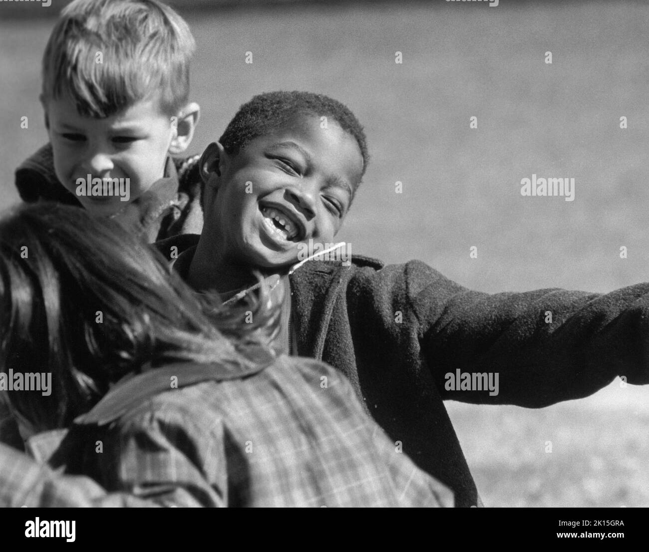 Children playing during recess at an integrated NC school in the late 1960's, after the schools in Charlotte were sucessfully integrated. Stock Photo