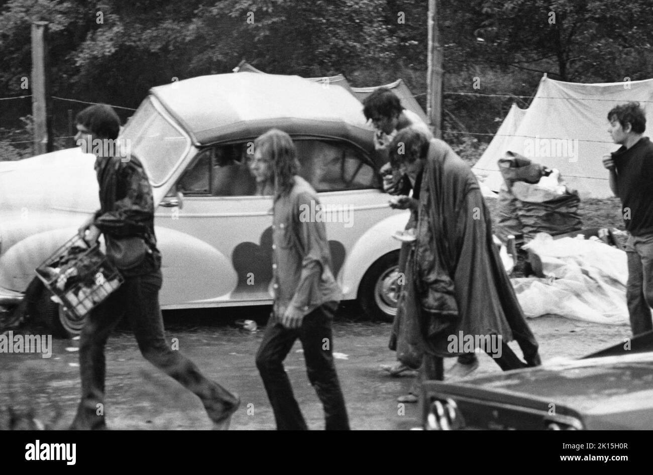 People walk in the rain during the Woodstock Music Festival in Bethel, NY; 1969. Stock Photo