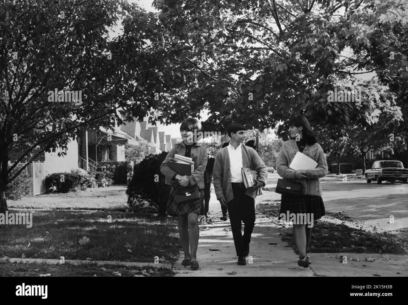 Teenagers walk to school; 1962. Stock Photo