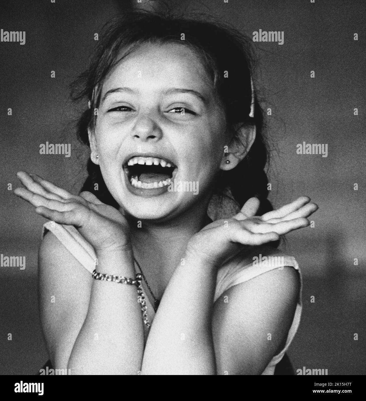 The photograph is captioned: 'Young girl laughs in delight during ballet practice in Rochester, New York.' 1978 Stock Photo