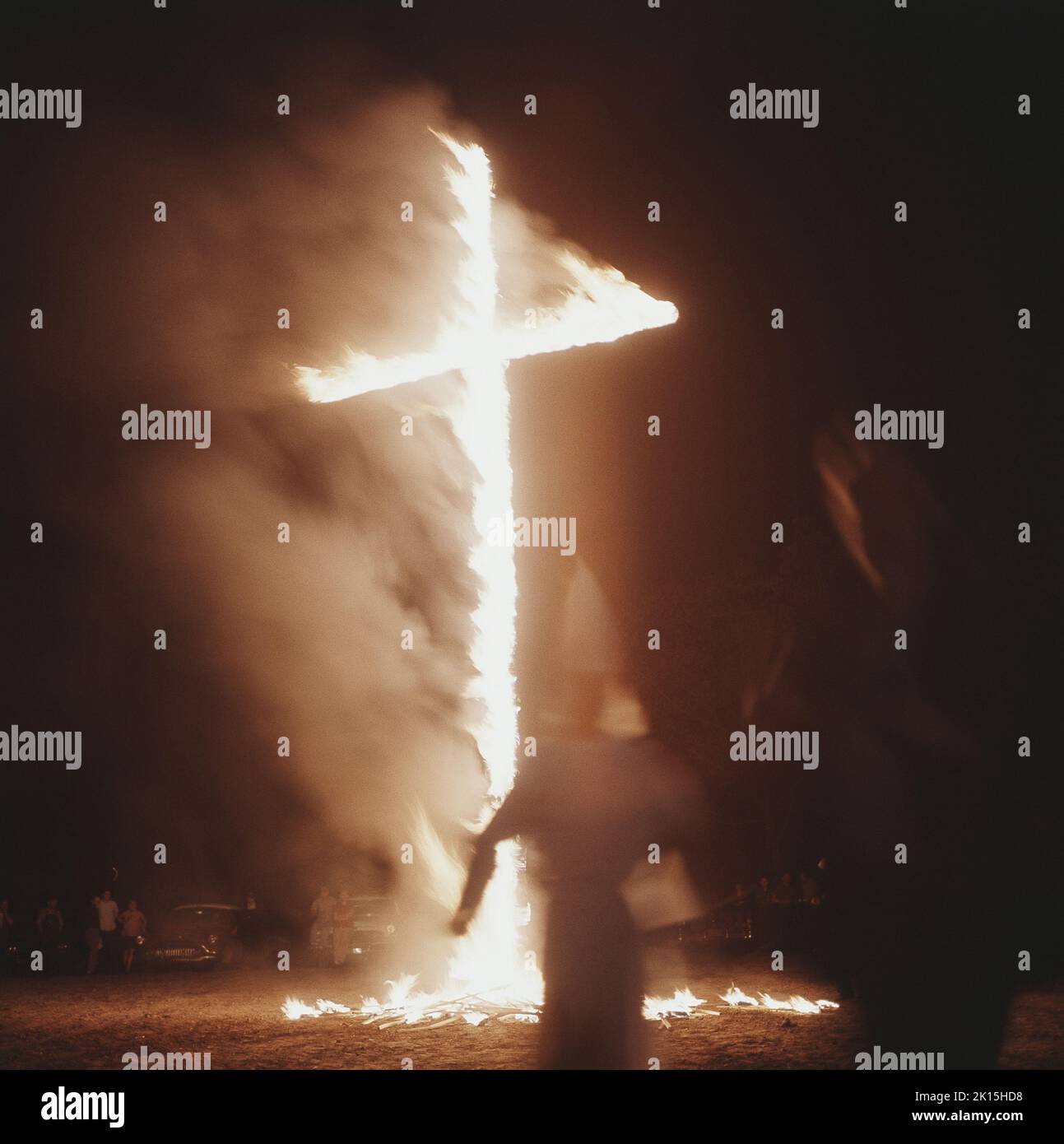 A cross burning at a Ku Klux Klan (KKK) meeting near Greenboro, North Carolina, mid-1960s. Stock Photo
