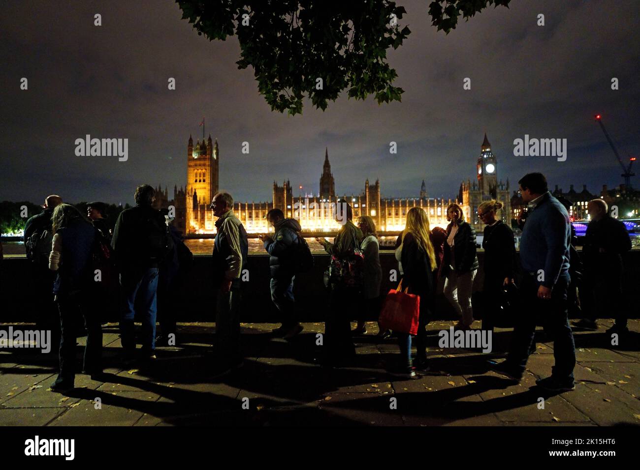 Members of the public in the queue on the South Bank in London opposite the Palace of Westminster, as they wait to view Queen Elizabeth II lying in state ahead of her funeral on Monday. Picture date: Thursday September 15, 2022. Stock Photo