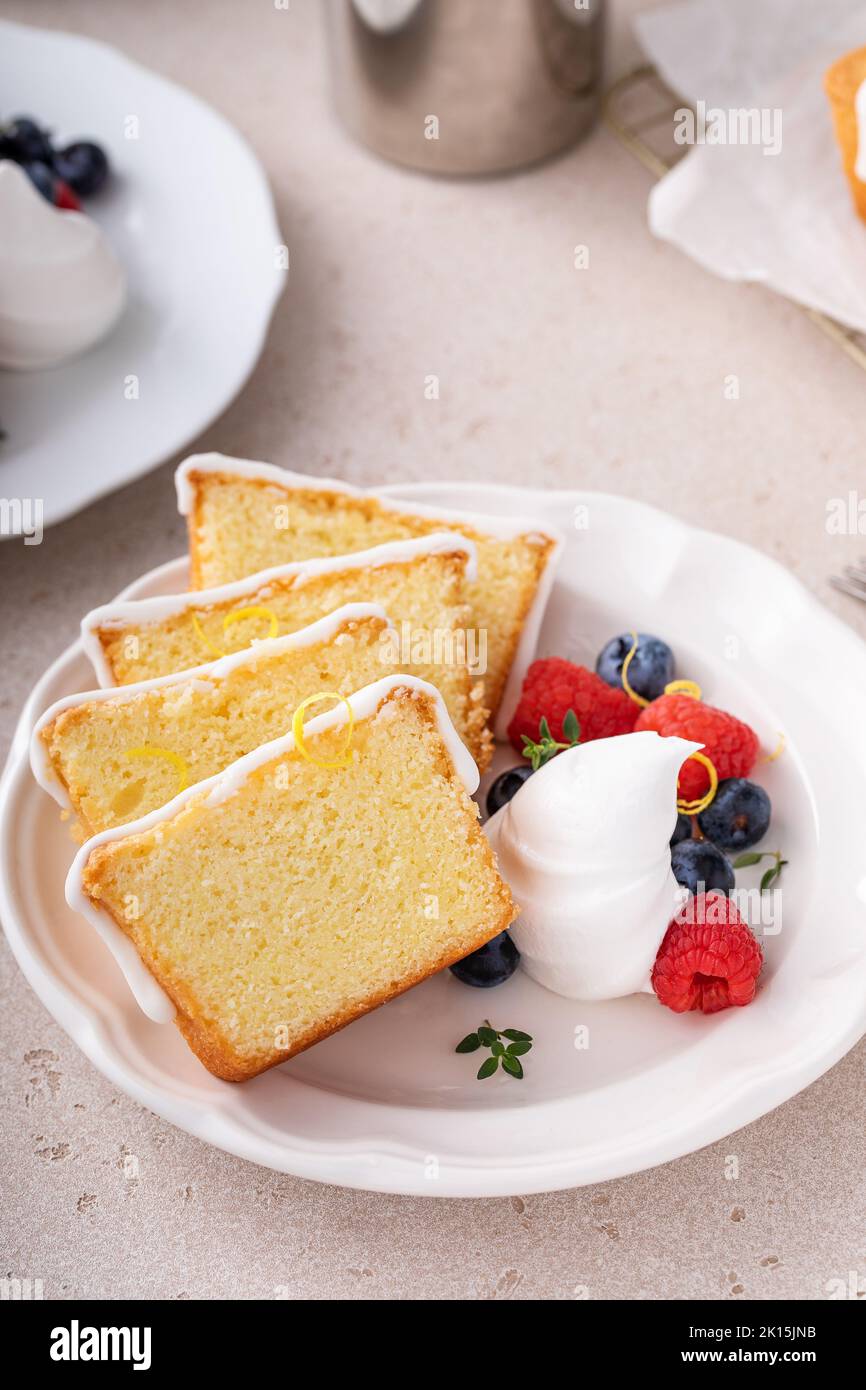 Classic vanilla or lemon pound cake served with fresh berries and whipped cream Stock Photo