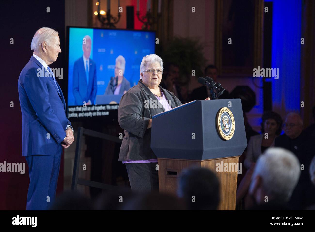 Washington DC, USA. 15th Sep, 2022. President Joe Biden looks on as Susan Bro, mother of Heather Hoyer, speaks during the United We Stand Summit which focused government efforts to combat violence and hate crimes in the East Room at the White House in Washington, DC on Thursday, September 15, 2022. Heather Heyer was killed during the Unite The Right rally in Charlottesville, Virginia in 2017. Photo by Bonnie Cash/UPI Credit: UPI/Alamy Live News Stock Photo