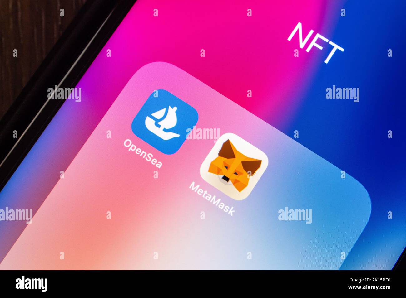 Vancouver, CANADA - Sep 11 2022 : OpenSea and MetaMask icons on an iPhone on wooden table. NFT digital art platform and Web3 Dapps concept. Stock Photo