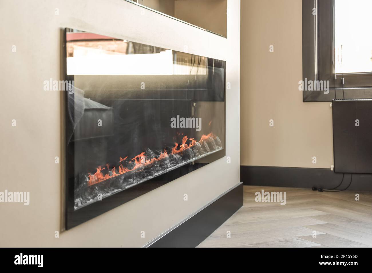 Side view of a lit indoor fireplace in a modern house Stock Photo - Alamy