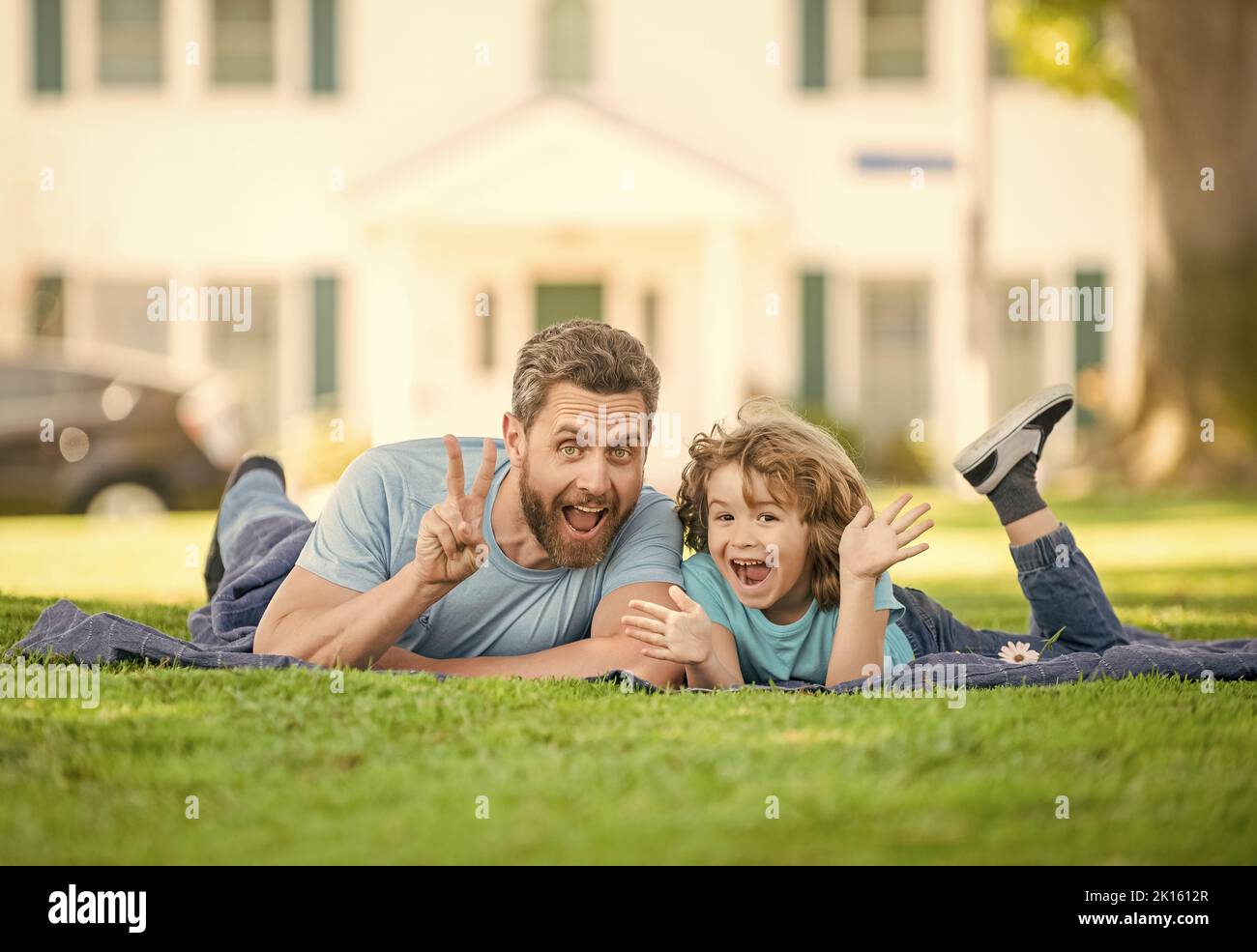 childhood and parenthood. parent relax with little child boy on grass. dad with kid Stock Photo