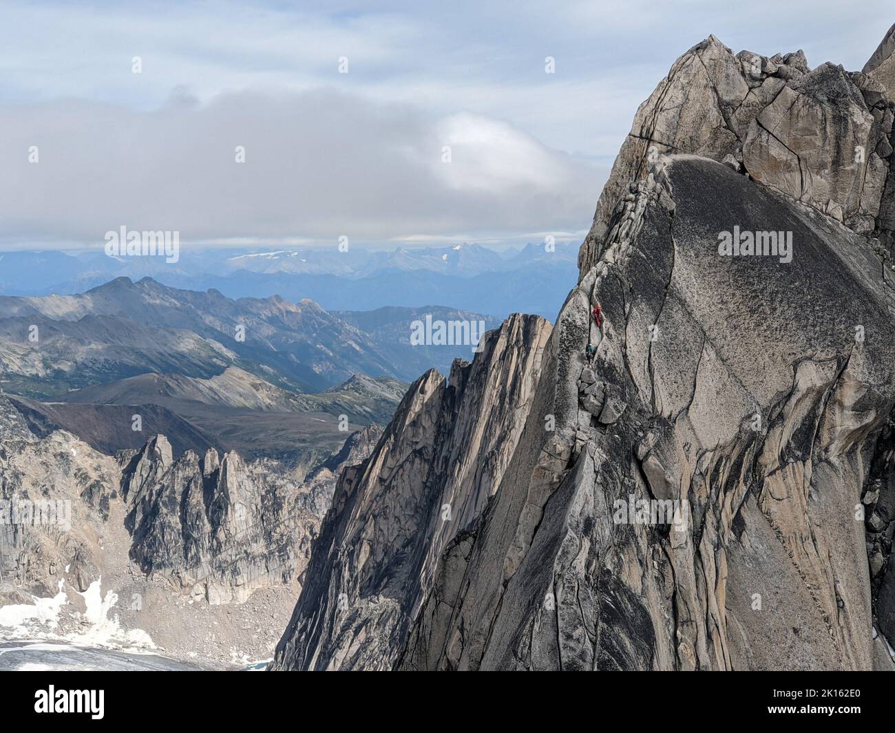 Climbers near summit of rocky peak in Bugaboos Provincial Park Stock Photo