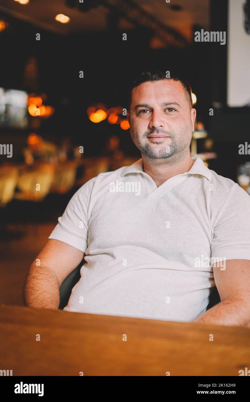 Middle aged man sitting in a bar having breakfast Stock Photo