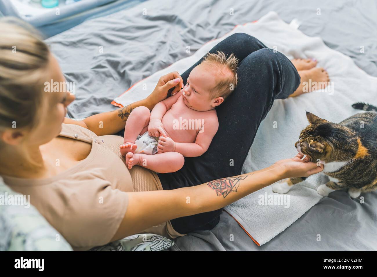 Curious baby boy sitting on bed hi-res stock photography and images - Alamy