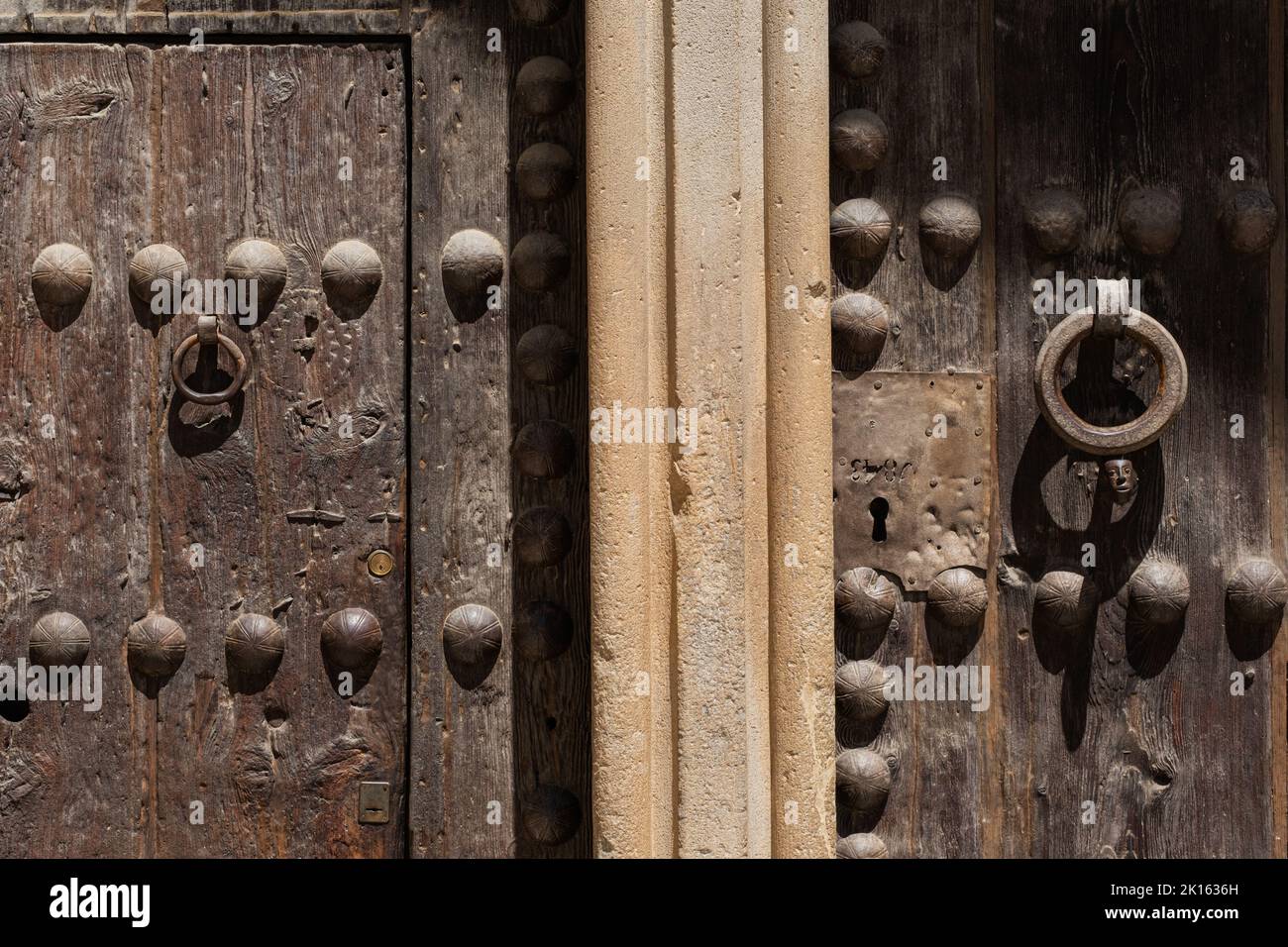 Front view of the main entrance to the Monastery of Sant Cugat del Vallès (Spain), a Benedictine abbey. Details of ancient medieval wooden doors. Stock Photo