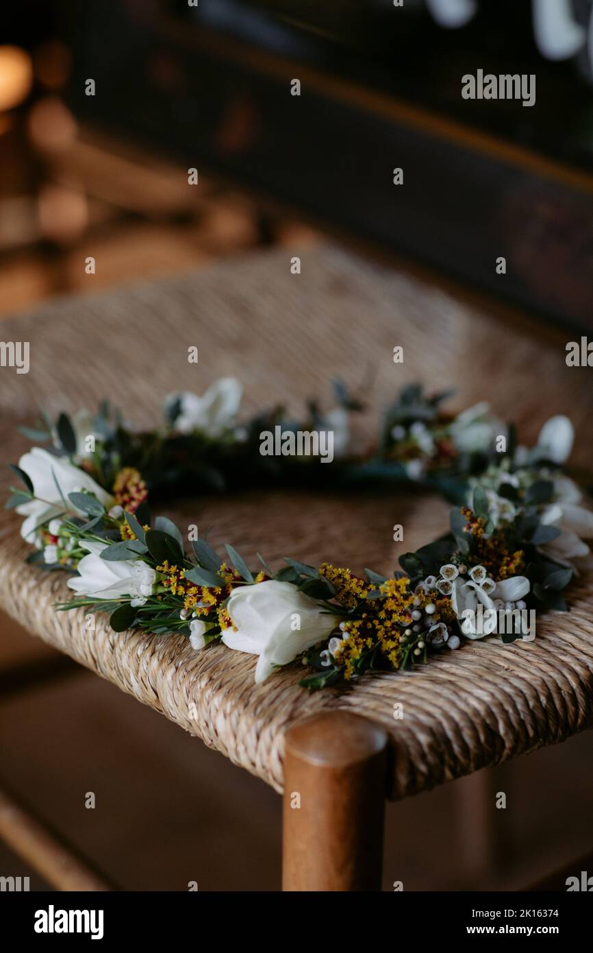 Flower crown resting on a woven wood stool Stock Photo
