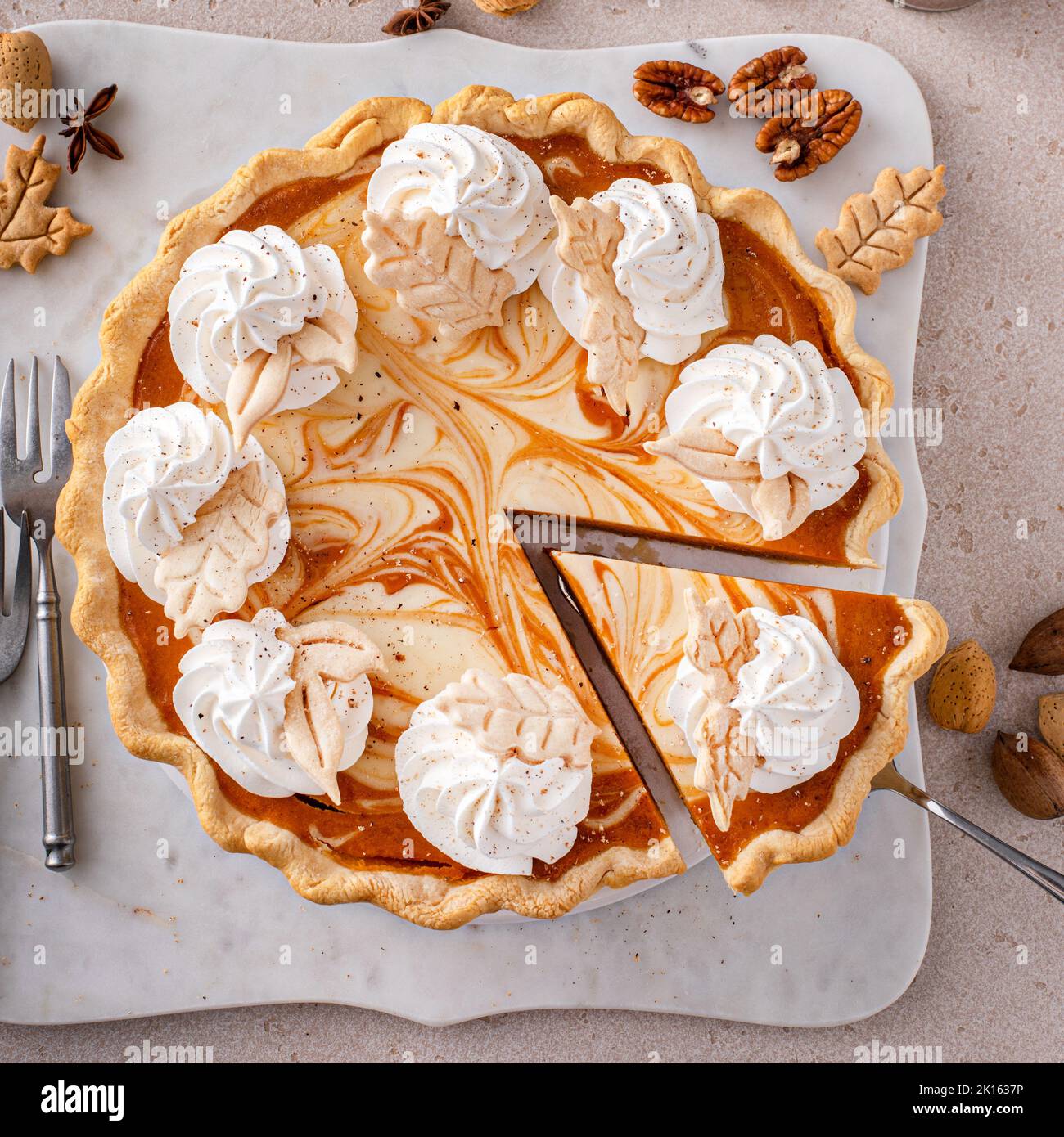 Pumpkin cheesecake swirl pie topped with whipped cream Stock Photo