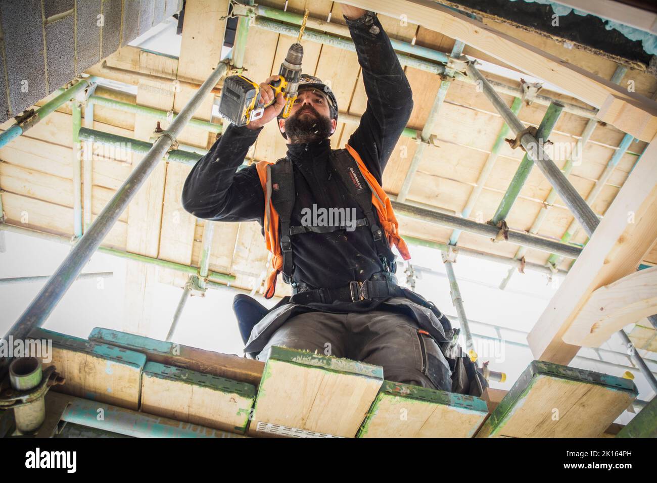 A carpenter / joiner working at a building site in Hampshire UK. Affordable housing UK. Stock Photo