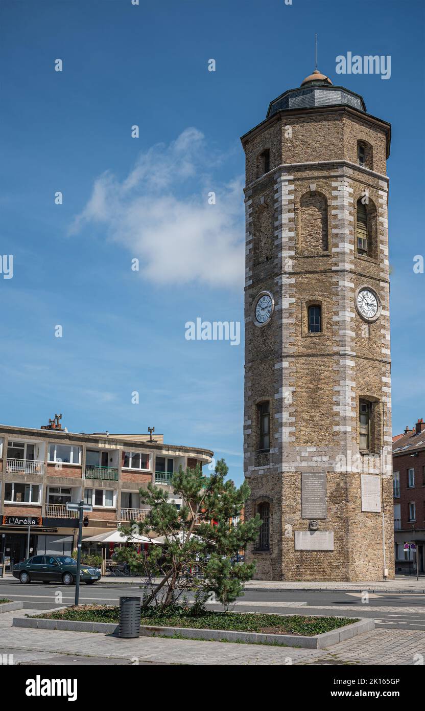 Europe, France, Dunkerque - July 9, 2022: Closeup of brown stone historic clock tower called Le Leughenaer against blue cloudscape set on roundabout a Stock Photo