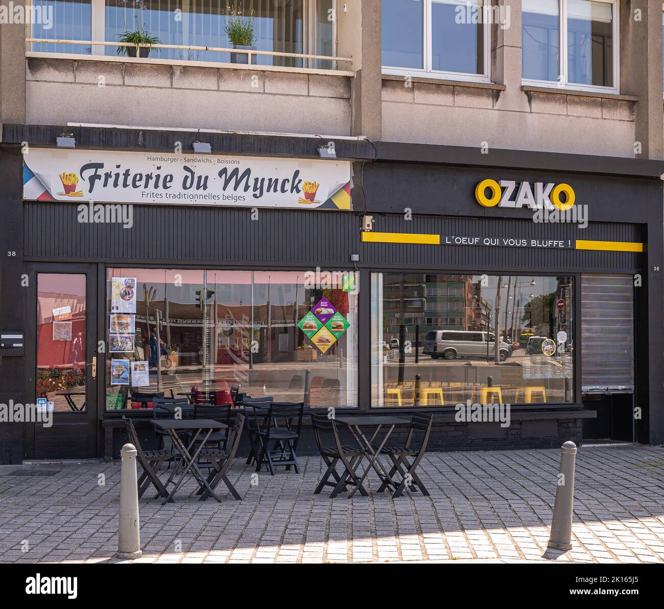 Europe, France, Dunkerque - July 9, 2022: Friterie du Mynck and Ozako Japanese restaurant black facades are neighbors on Place du Mynk. Windows mirror Stock Photo