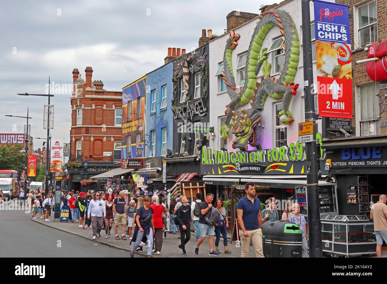 Shops with tourists & shoppers, in Camden High Street, Camden Town, London, England, UK, NW1 8QR Stock Photo