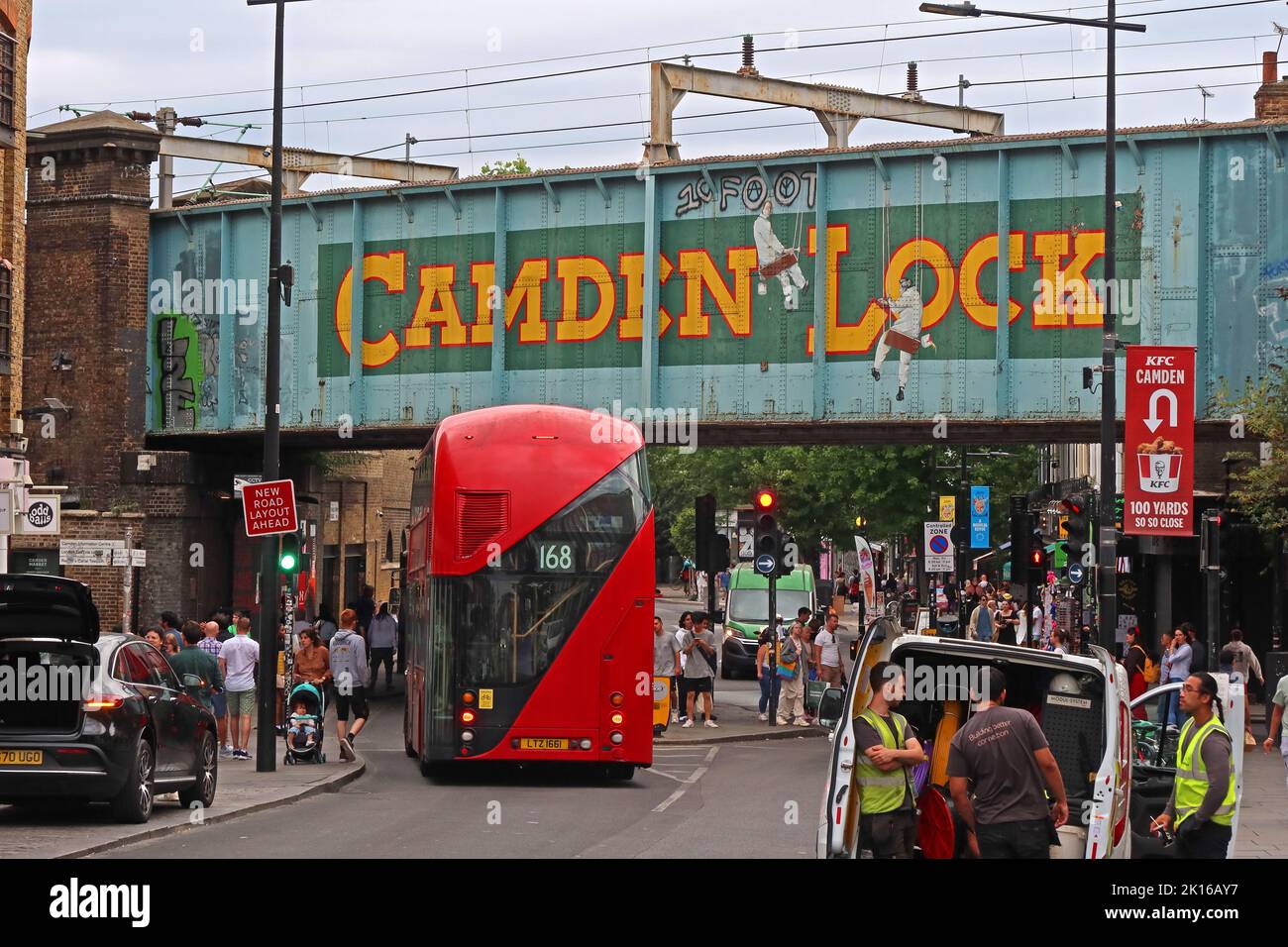 Famous Camden Lock railway bridge, busy with visitors, with red London Routemaster bus no 168, Camden Town, London,England, NW1 8AF Stock Photo