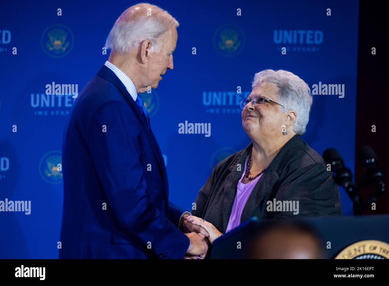 Washington DC, USA. 15th Sep, 2022. United States President Joe Biden shakes hands with Susan Bro, right, mother of Heather Heyer, who was killed at the Unite the Right rally in Charlottesville, Virginia in 2017, prior to making remarks at the United We Stand Summit in the East Room of the White House in Washington DC, USA, 15 September 2022. Credit: Jim LoScalzo/Pool via CNP/dpa/Alamy Live News Stock Photo