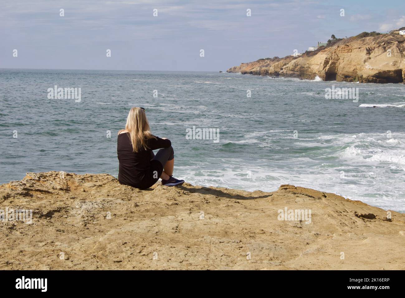 lady sitting on the cliffs Stock Photo - Alamy