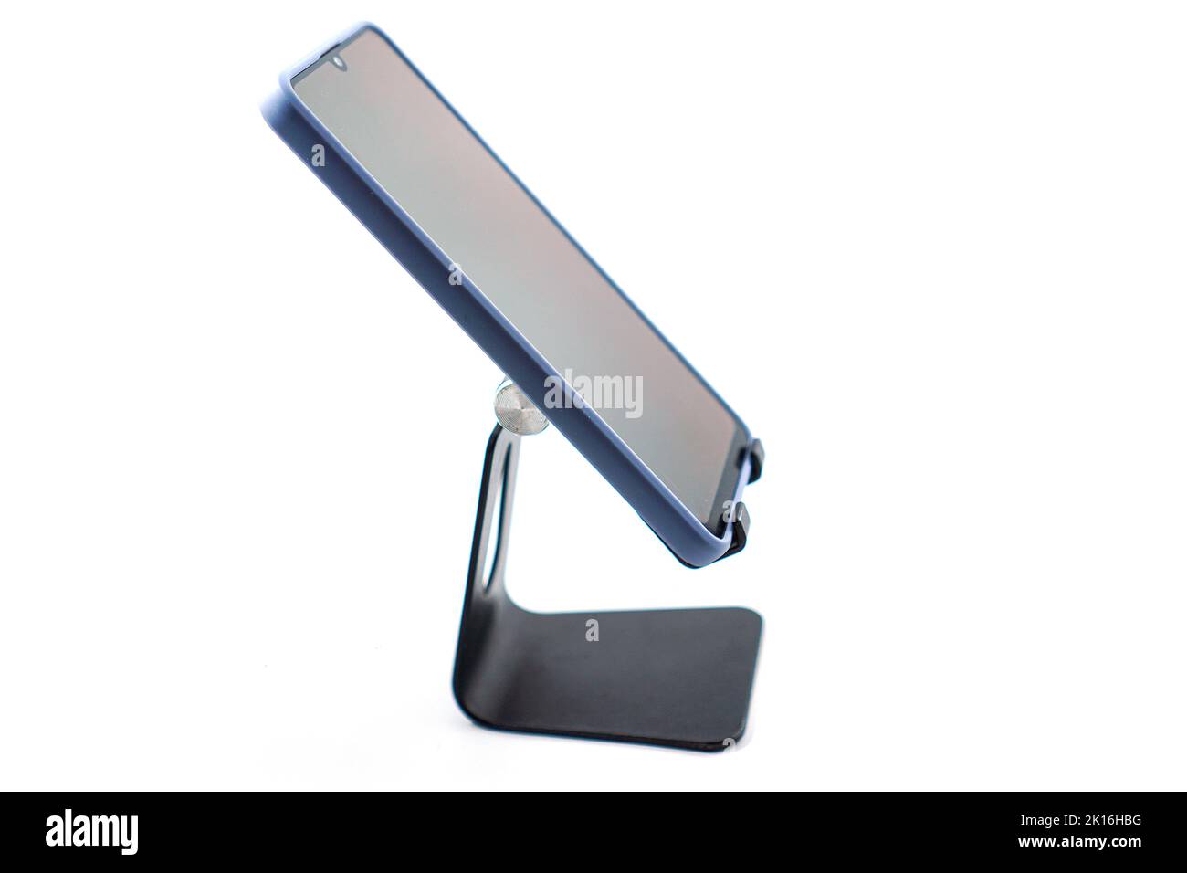 phone holder desk black aluminum metal with smartphone isolated on white background Stock Photo