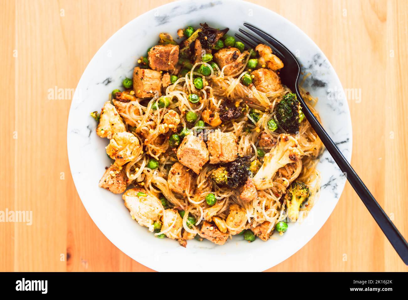 plantbased noodles stir fry with broccoli peas and marinated tofu