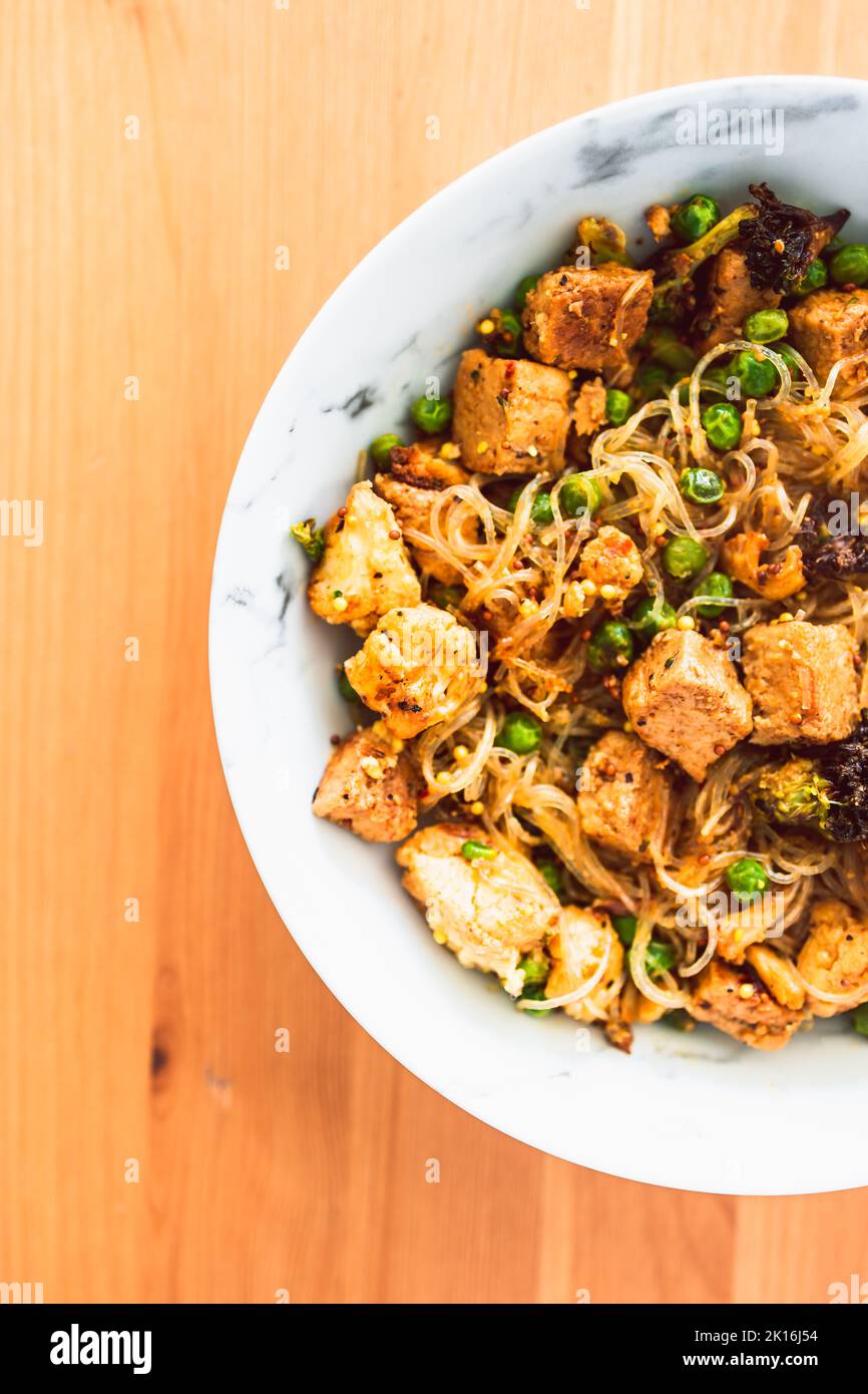 plantbased noodles stir fry with broccoli peas and marinated tofu