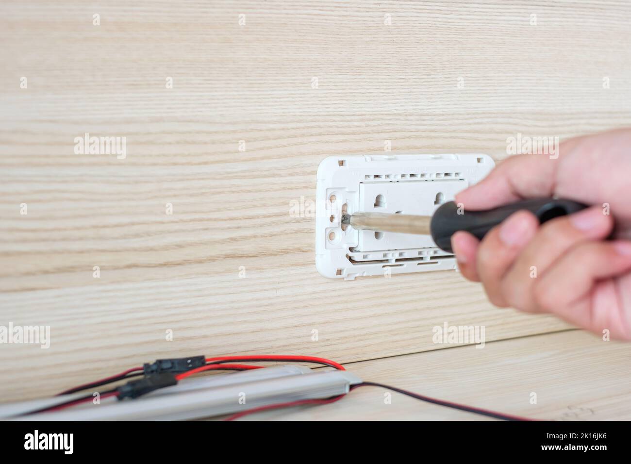 Man hand using screwdriver installing Wire cables for socket plug