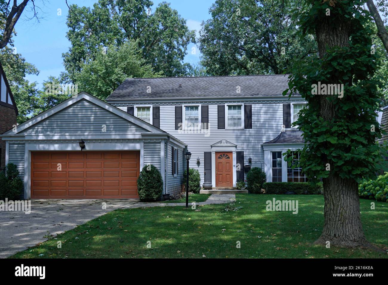 Traditional two story detached suburban house with two car garage Stock Photo
