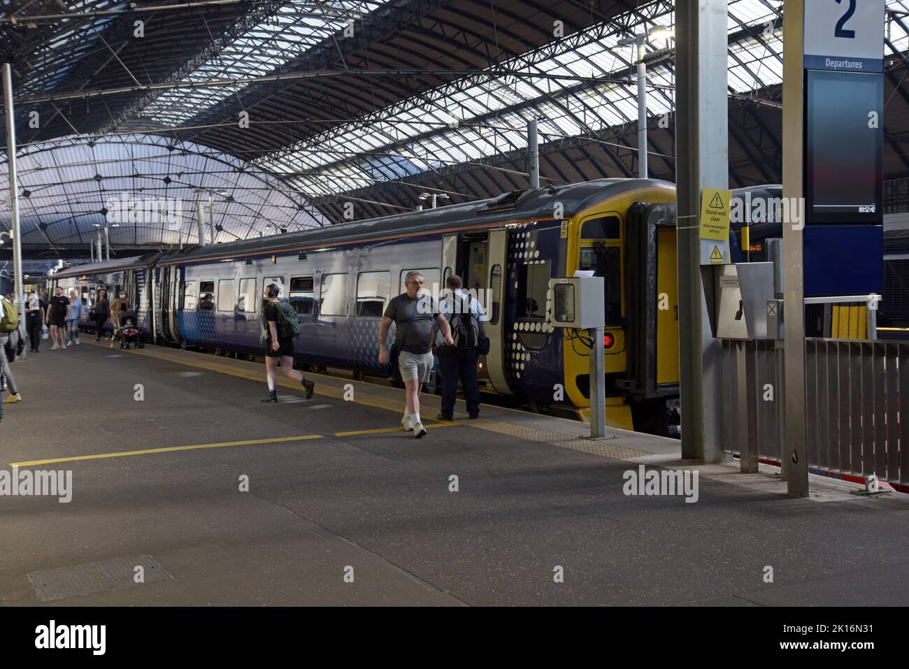 Passengers making their way to get on board a Scotrail Class 158