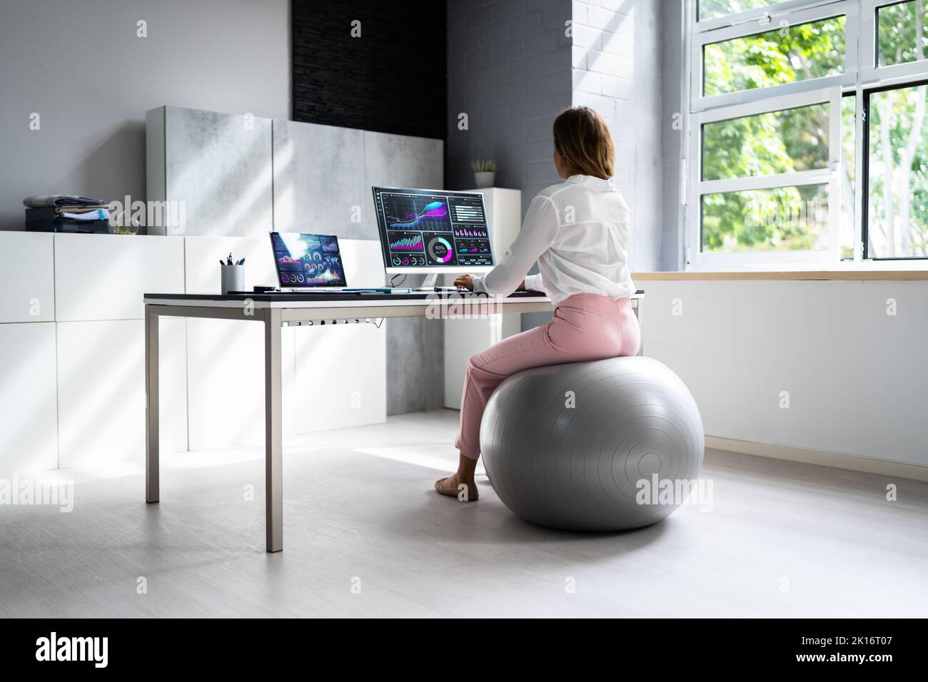 Correct Posture At Desk In Office Using Fitness Ball Stock Photo Alamy
