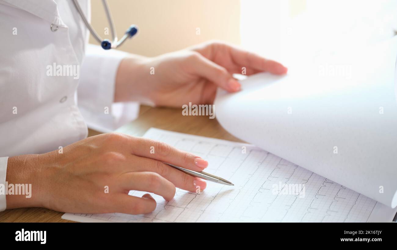 Cardiologist examines heart disease and electrocardiogram of patient Stock Photo