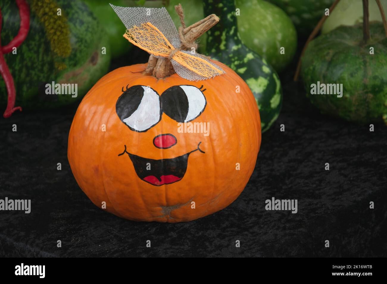Halloween scene, a blissful smile on a big orange pumpkin Stock Photo