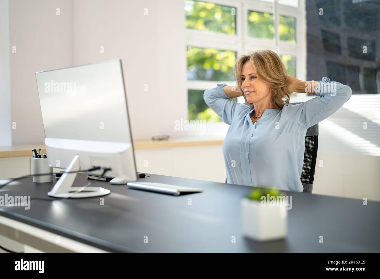 Stretch Arm Exercises While Working At Office Computer Stock Photo Alamy