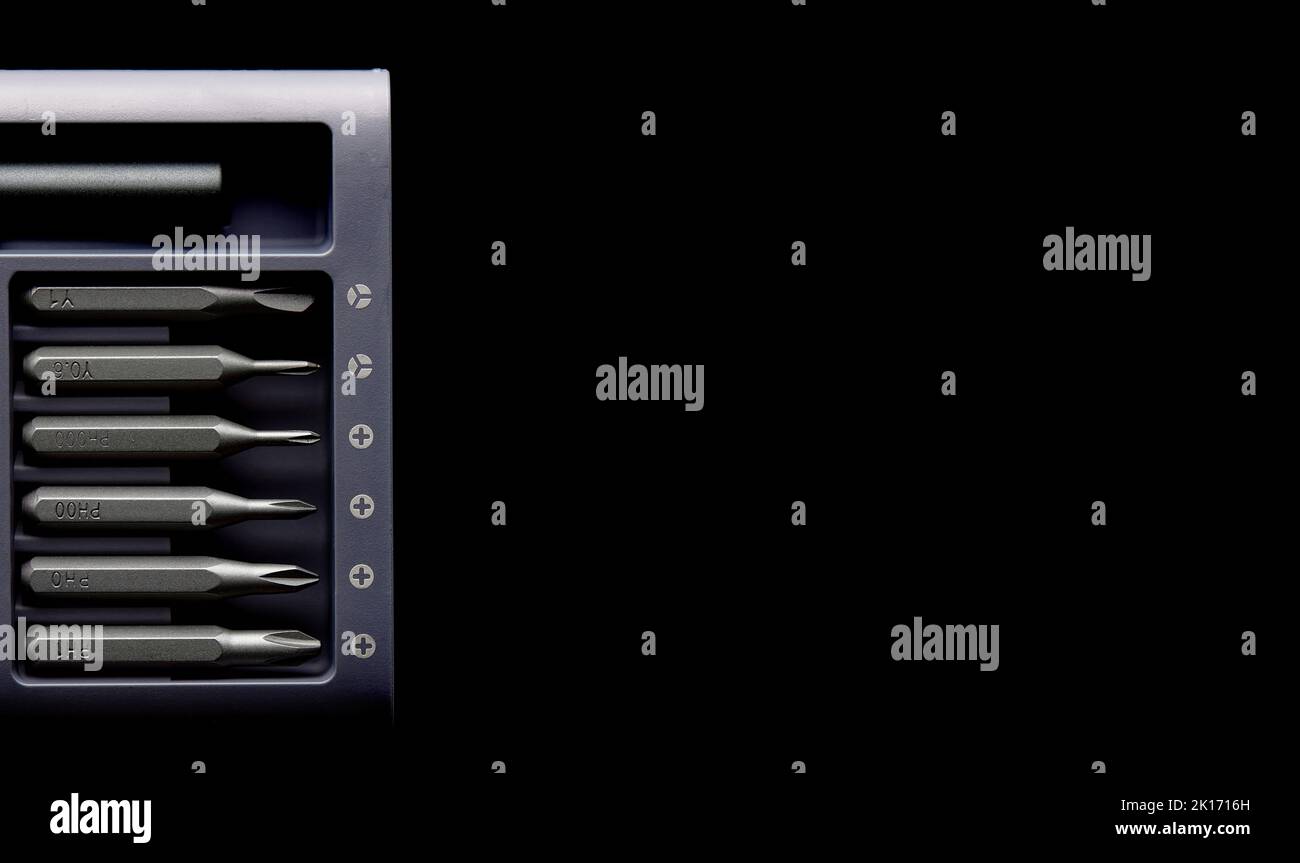 Screwdriver tips different shapes and sizes close up. Manual metal mini screwdriver and set of