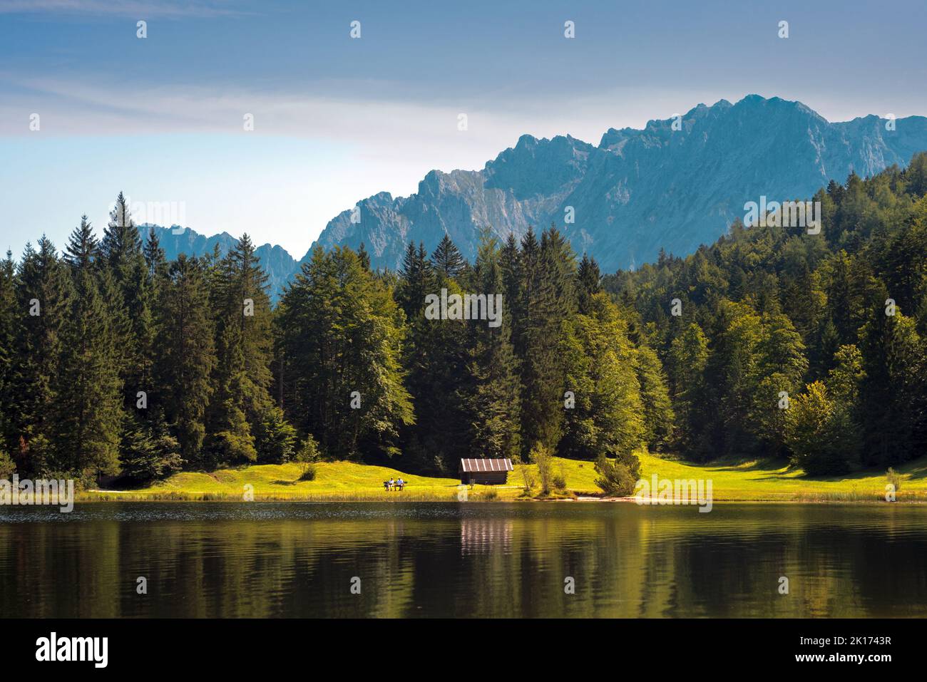 Alpine lake shore with old wooden barn Stock Photo