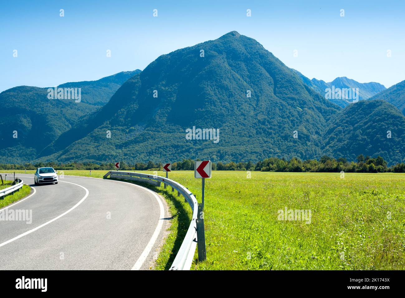 Road with distant car against mountains Stock Photo