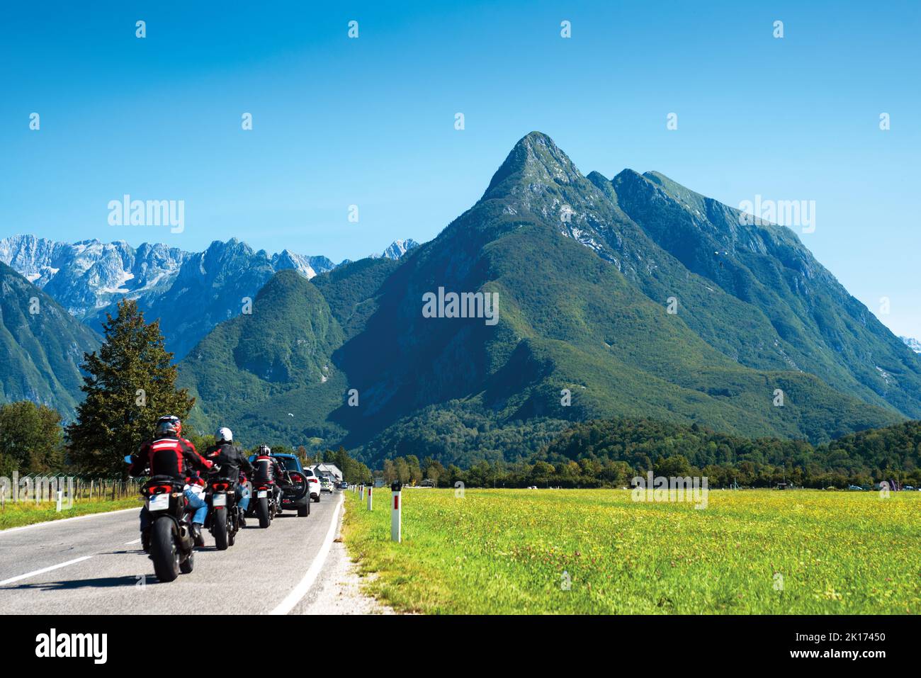 Motorcyclist column moving on alpine highway Stock Photo
