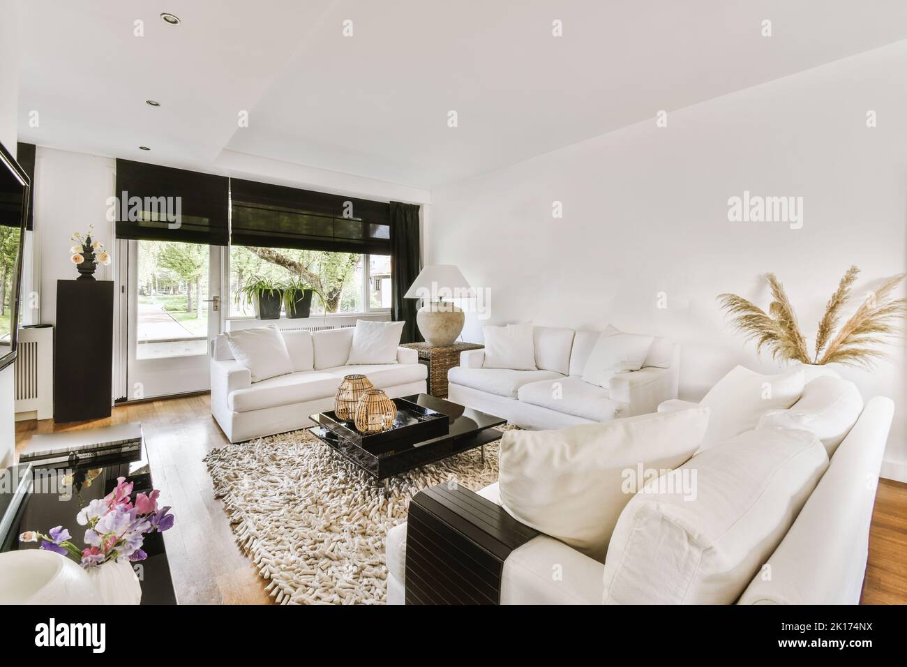 Stylish interior design of living room with light furniture and soft