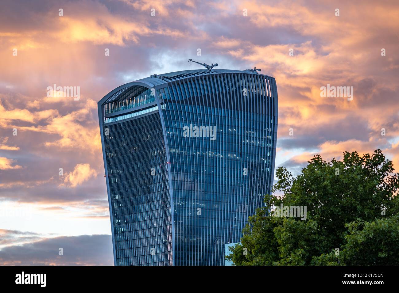 Sky Garden, 20 Fenchurch Street, aka the Walkie-Talkie, shot from Tower Bridge at dusk against a flaming orange sunset sky. Stock Photo