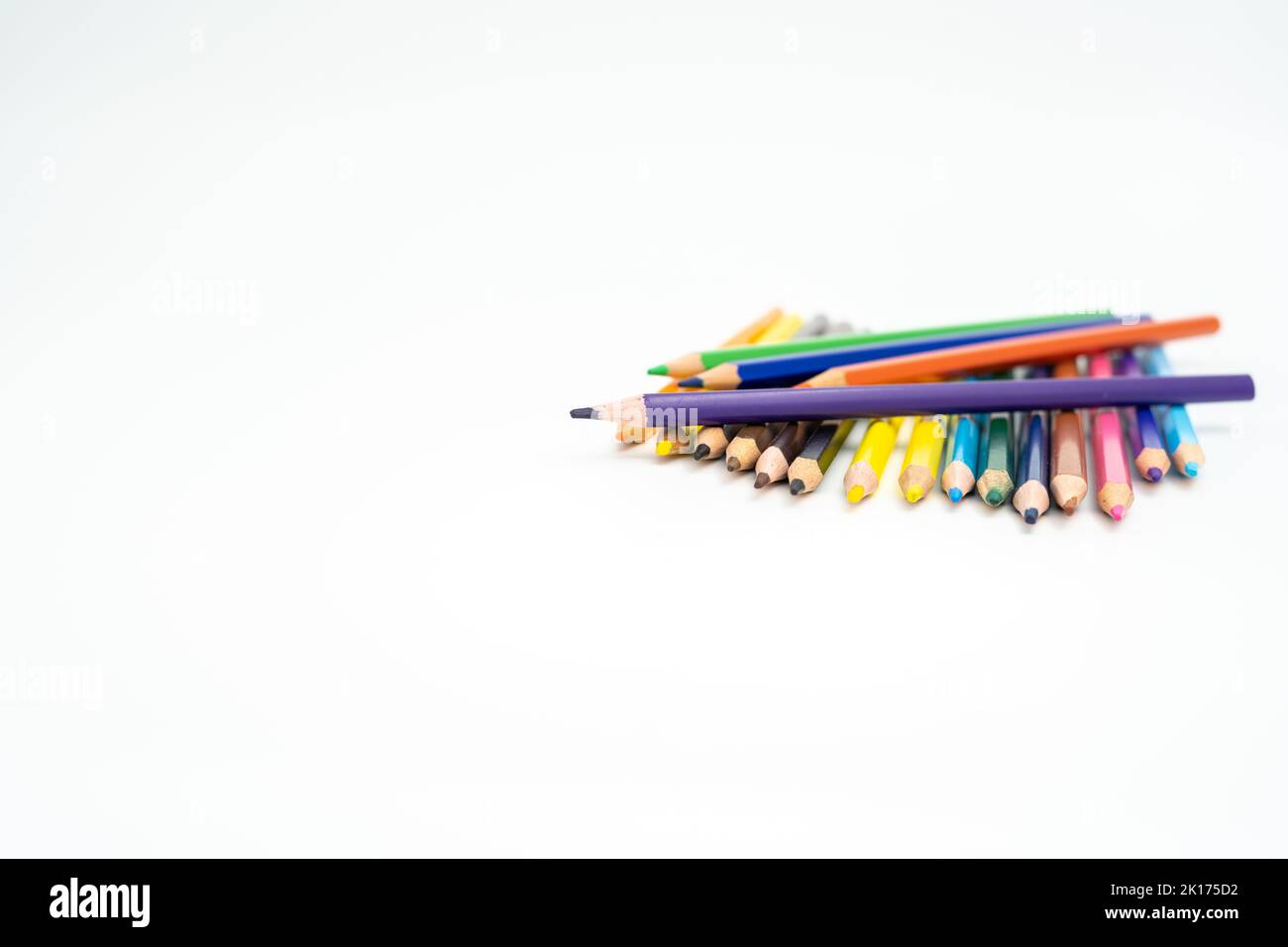 wooden colored pencils on a white background with a point (lead) in focus Stock Photo